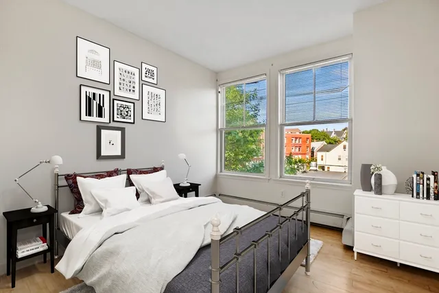 a bedroom with a bed and a window