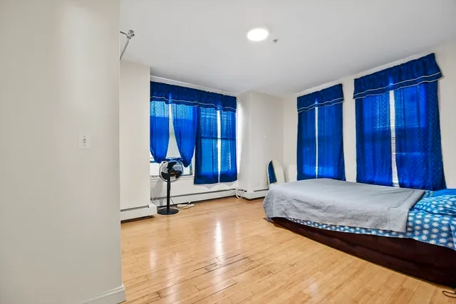 a living room with a bed and gym equipment