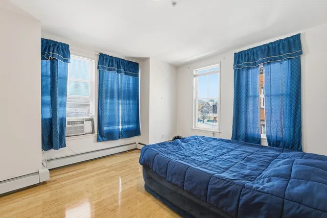 a bedroom with a large bed and a dresser