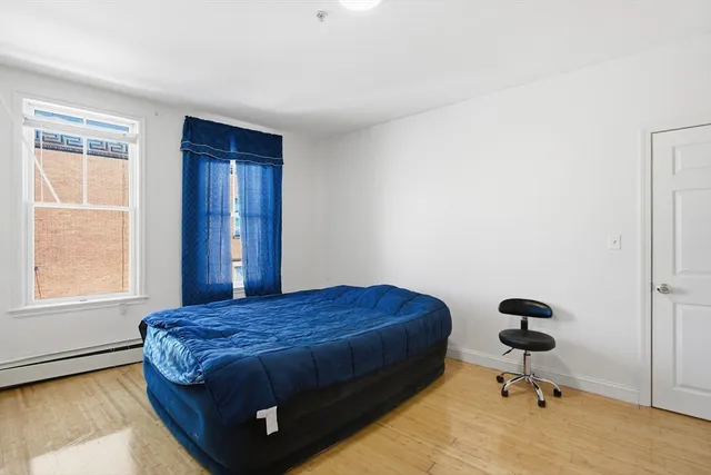 a bedroom with a bed and a window