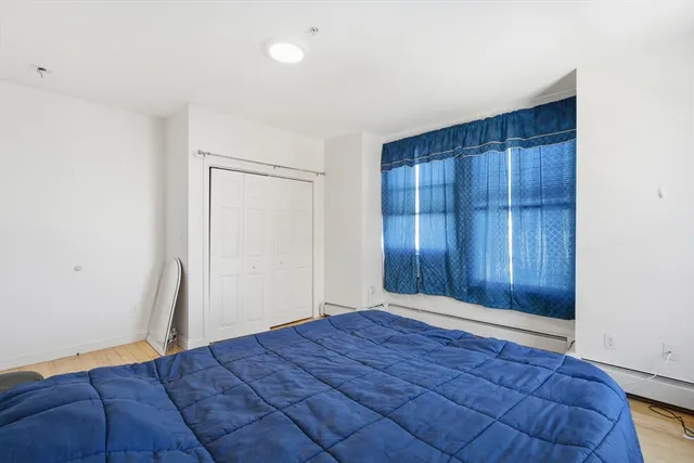 a view of room with hardwood floor and hallway