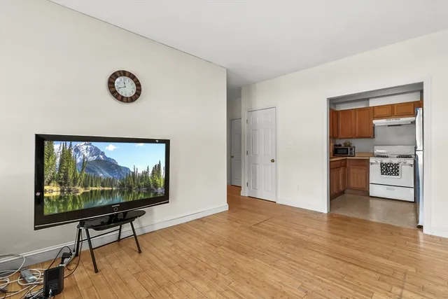 a view of a livingroom with furniture and a flat screen tv