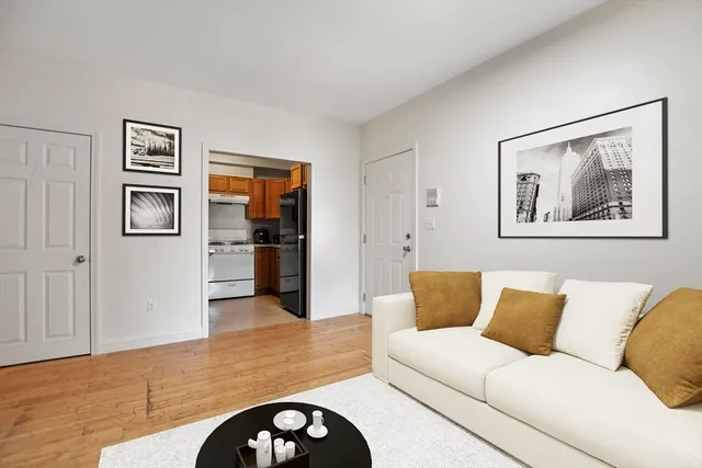 a living room with furniture and painting on the wall