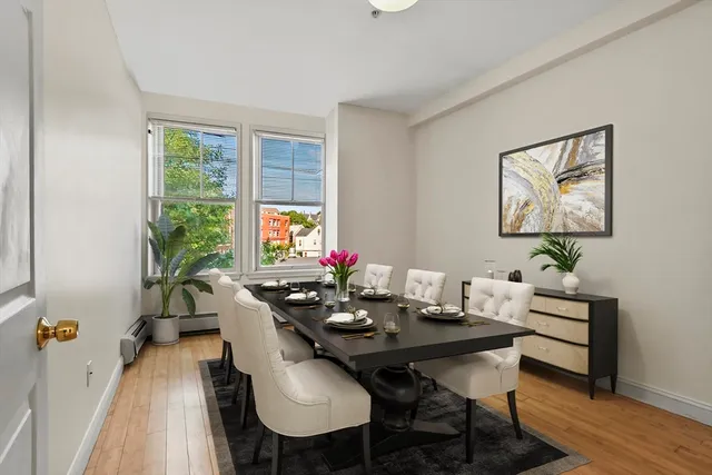 a view of a dining room with furniture window and wooden floor