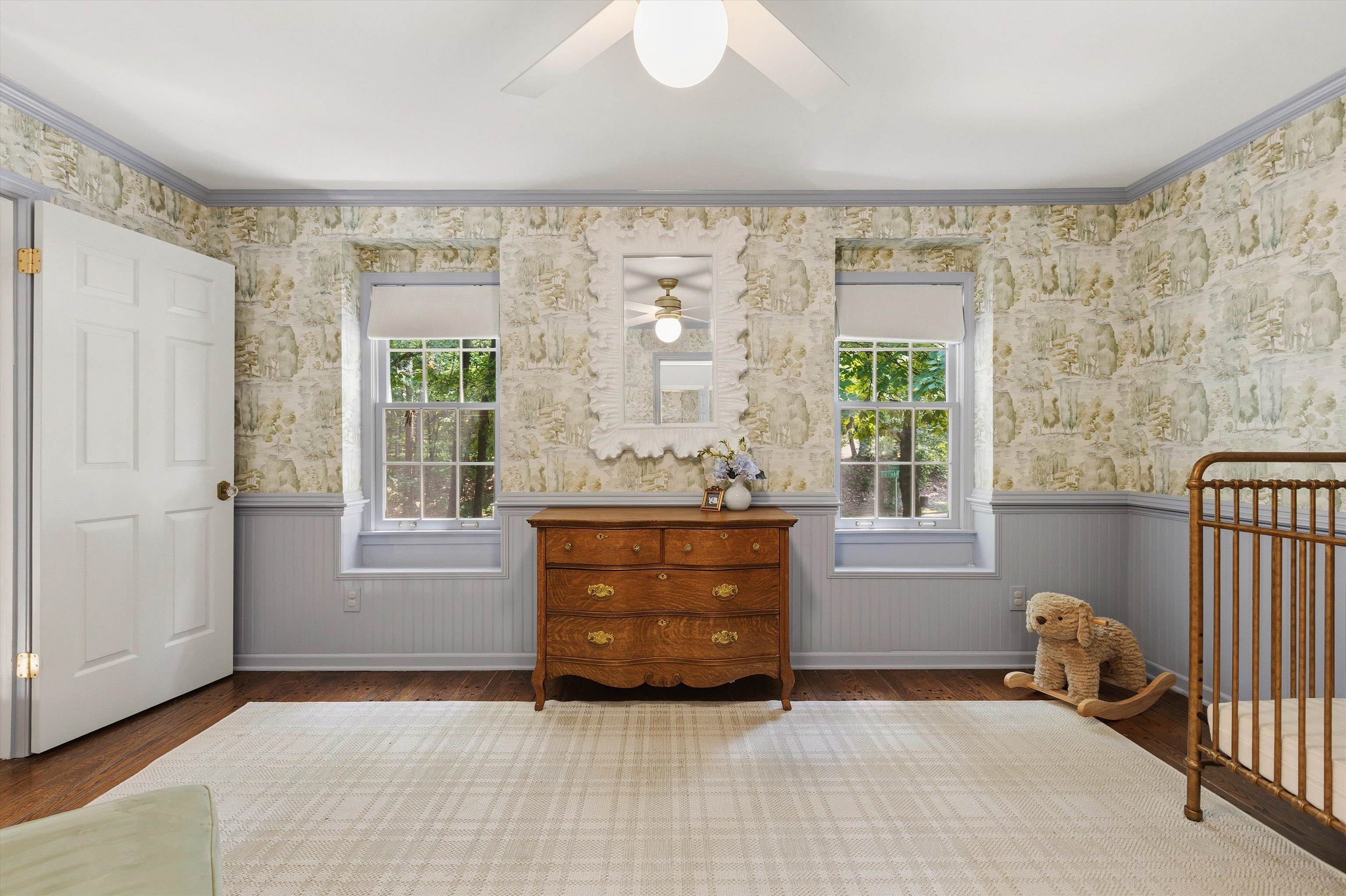 5828 Haymarket Road Memphis, TN 38120 - Photo 30 of 40 Spacious room featuring patterned wallpaper, light blue wainscoting, and wood-finish flooring