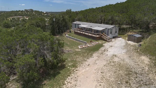 an aerial view of a house with a yard