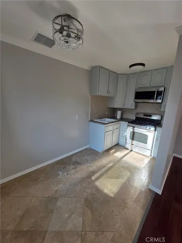a kitchen with kitchen island a sink stainless steel appliances and cabinets