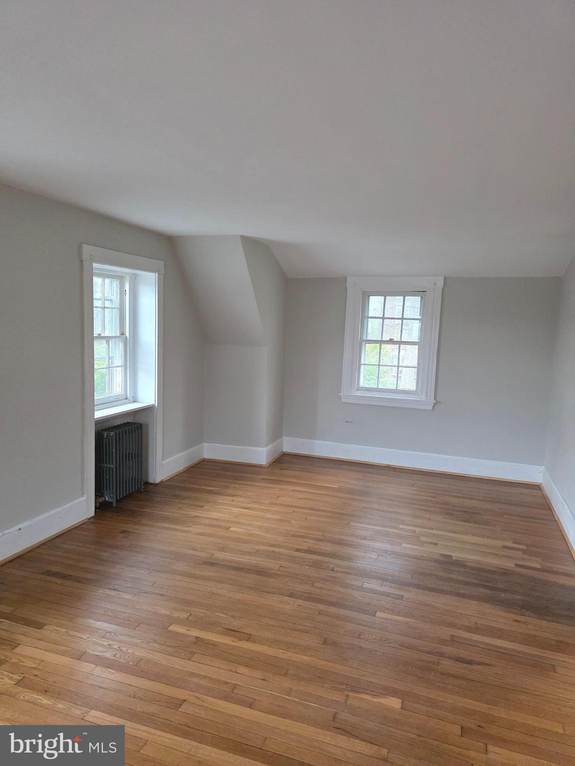 14 Avon Road Narberth, PA 19072 - Photo 12 of 17 an empty room with wooden floor and windows