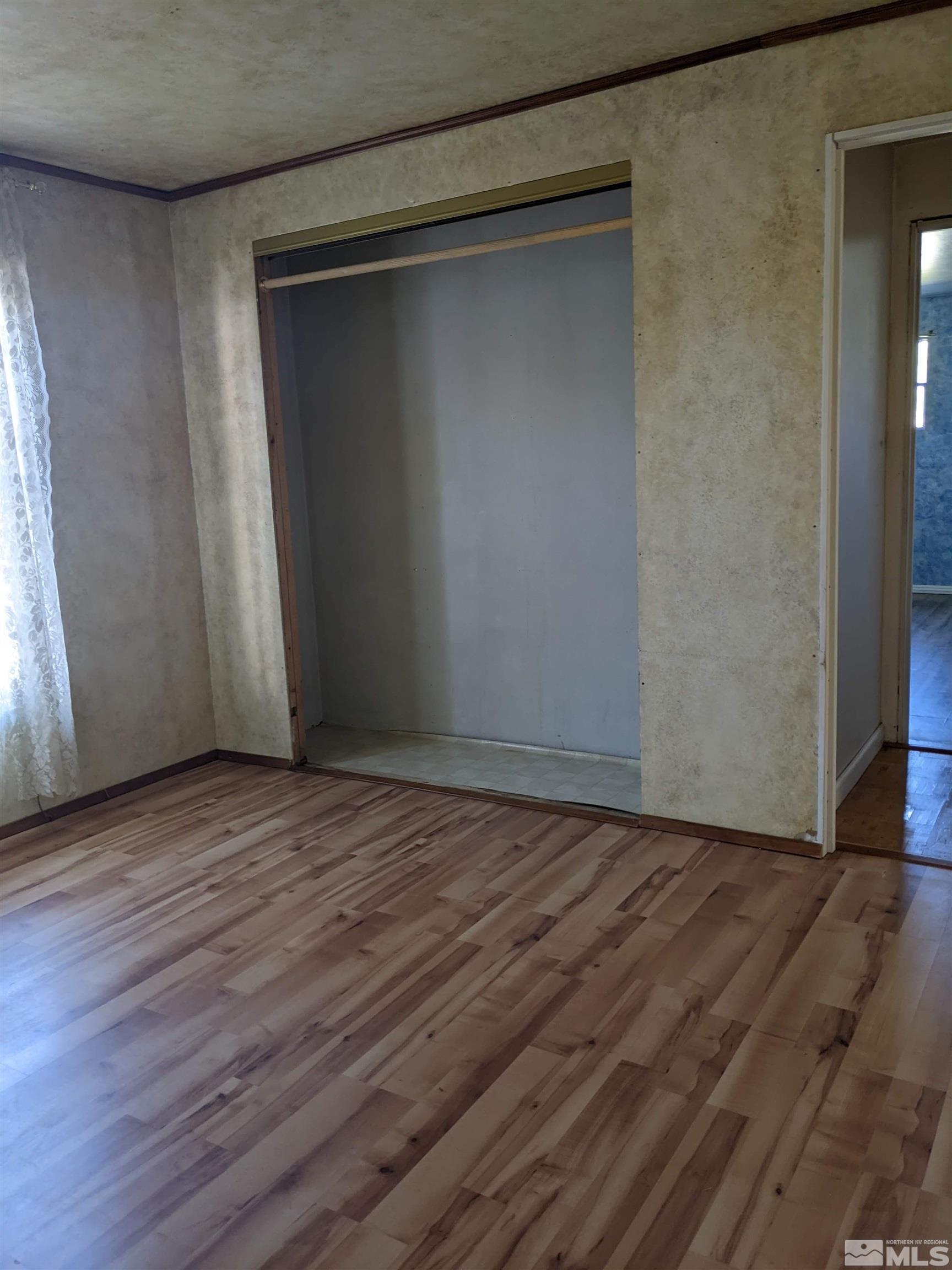 3960 Goldfinch Drive Reno, NV 89508 - Photo 10 of 15 a view of an empty room with wooden floor and a window