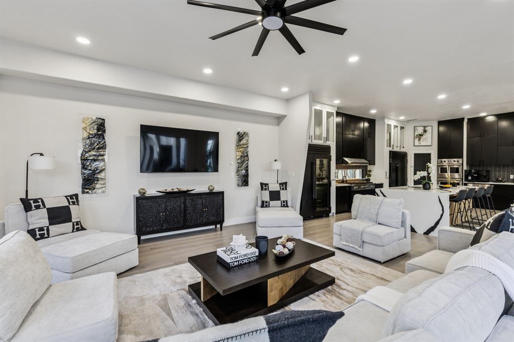 6 Savannah Ridge Frisco, TX 75034 - Photo 16 of 40 a living room with furniture a flat screen tv and a fireplace