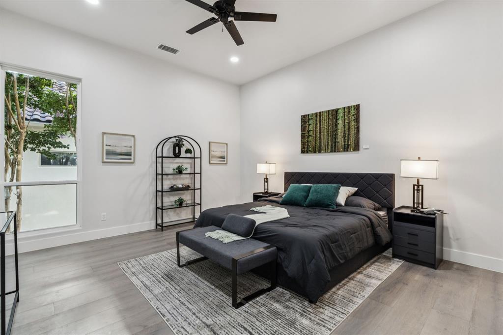 6 Savannah Ridge Frisco, TX 75034 - Photo 20 of 40 a bedroom with a large bed and a painting on the wall