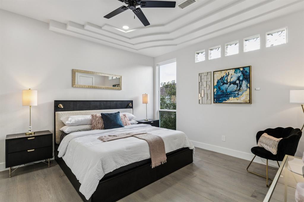 6 Savannah Ridge Frisco, TX 75034 - Photo 31 of 40 a bedroom with a bed and a chandelier