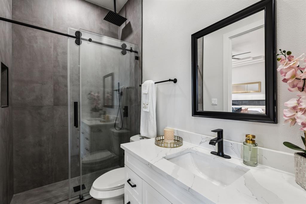 6 Savannah Ridge Frisco, TX 75034 - Photo 32 of 40 a bathroom with a granite countertop sink toilet mirror and shower