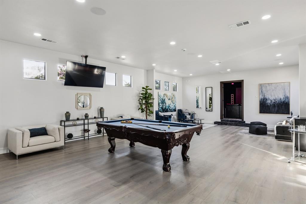6 Savannah Ridge Frisco, TX 75034 - Photo 33 of 40 a living room with furniture a flat screen tv and gym equipment