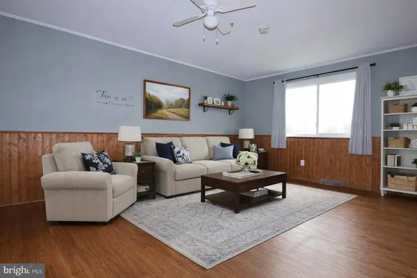 a living room with furniture and wooden floor
