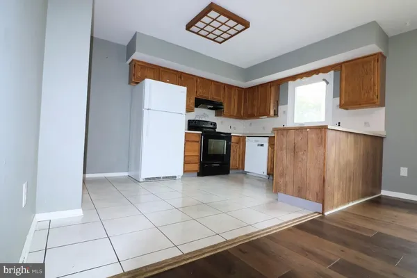 a view of kitchen with stainless steel appliances cabinets and a window
