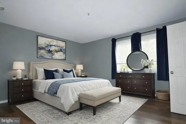 a bedroom with a bed and a dresser