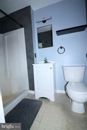 a bathroom with a toilet a sink and a mirror