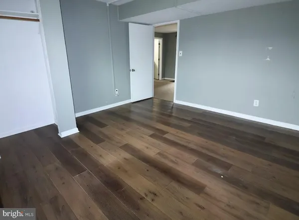 a view of deck with wooden floor and fence next to a yard