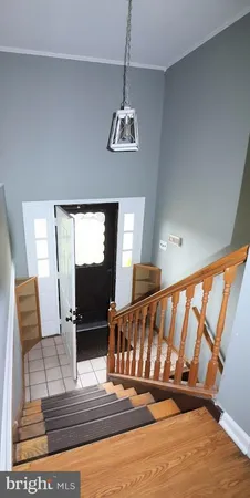 a view of staircase with wooden floor and windows