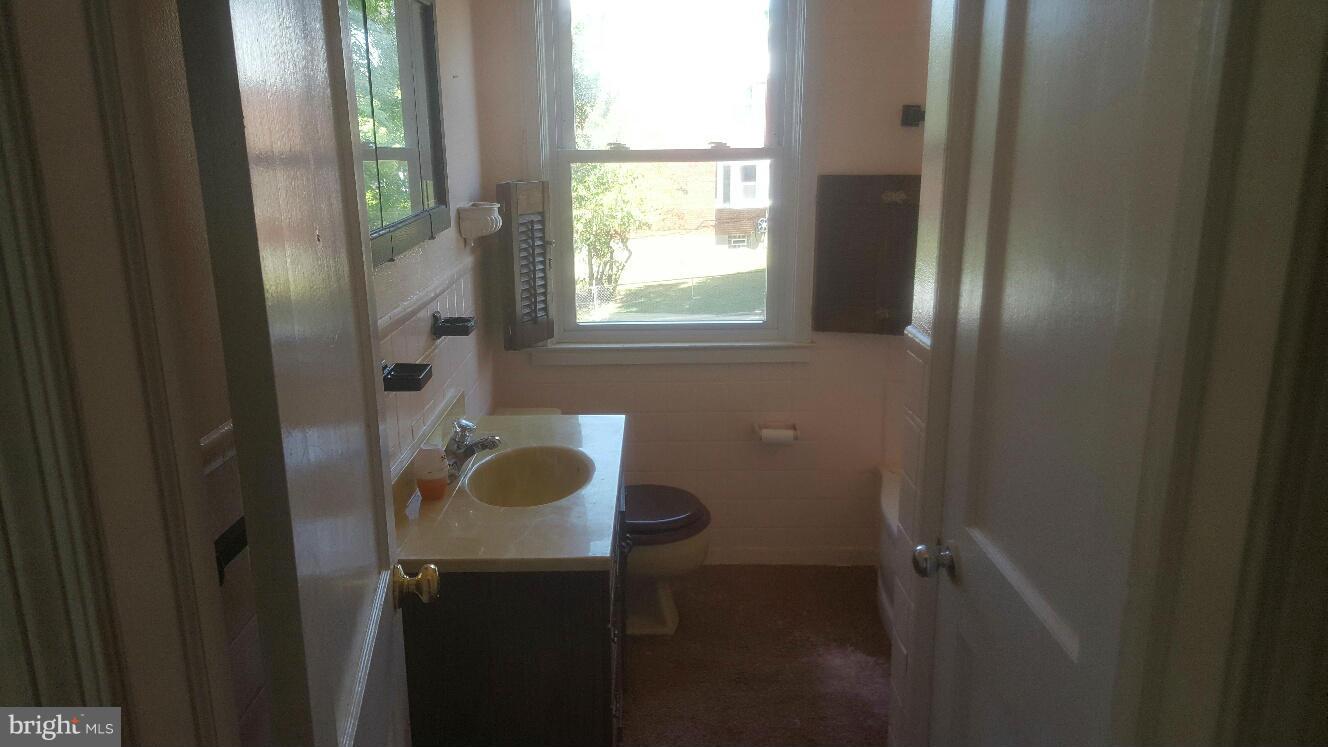 6224 Falkirk Road Baltimore, MD 21239 - Photo 6 of 11 a bathroom with a sink and a mirror