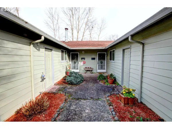 a backyard of a house with table and chairs
