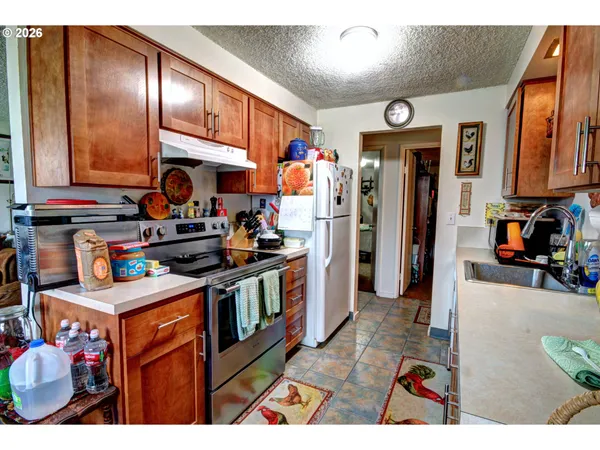 a kitchen filled with stainless steel appliances kitchen island granite countertop a refrigerator and a stove