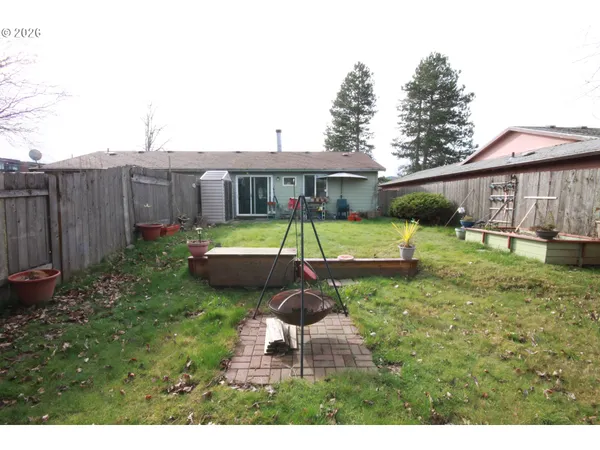 a backyard of a house with table and chairs