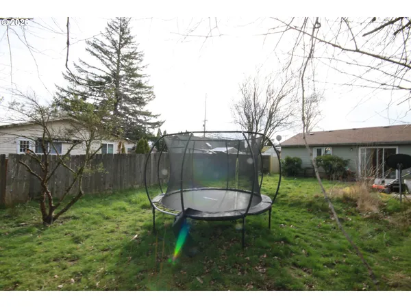 a backyard of a house with table and chairs