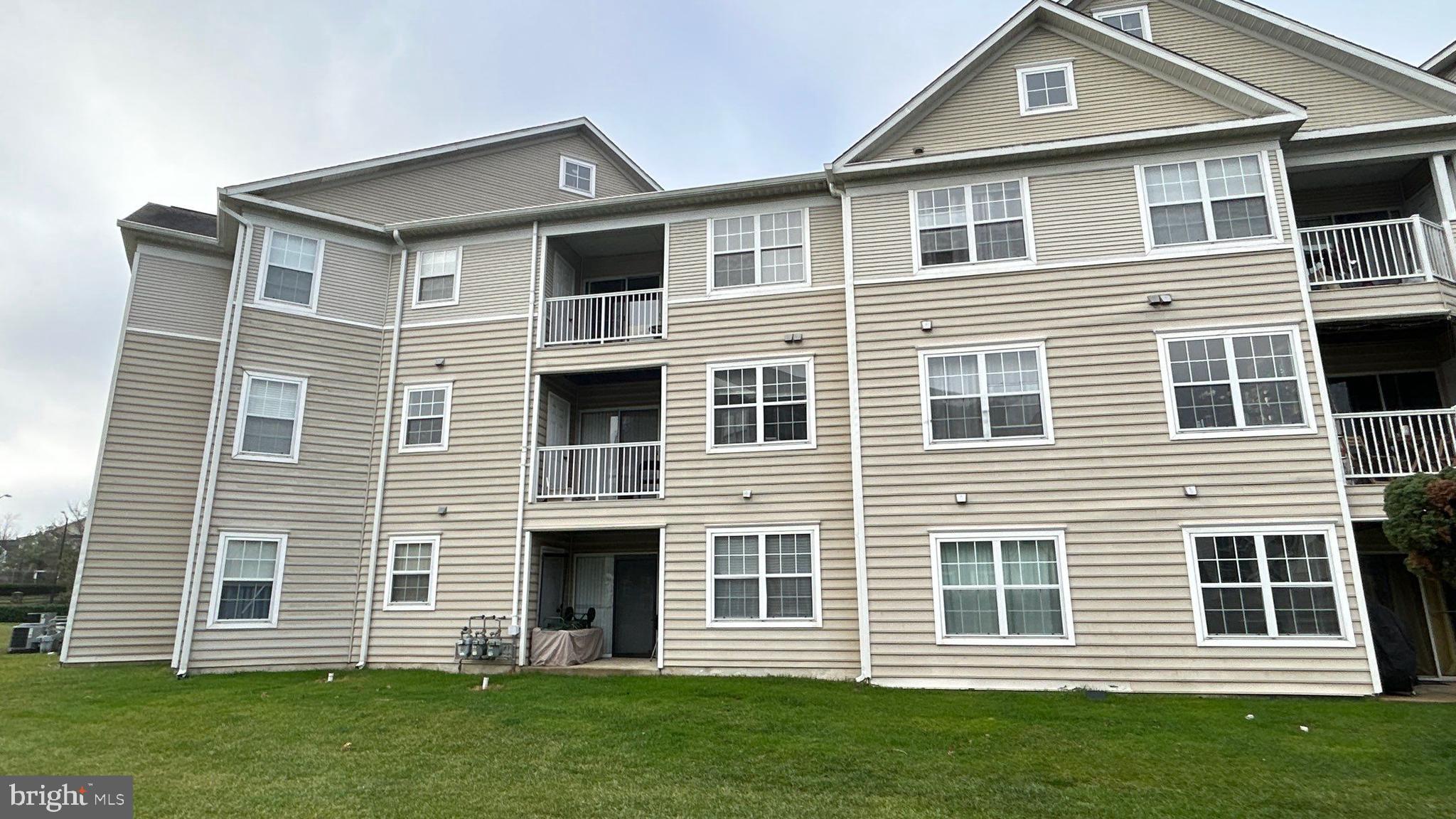 306 Gatehouse Lane, Unit E Odenton, MD 21113 - Photo 14 of 14 a front view of a house with a yard
