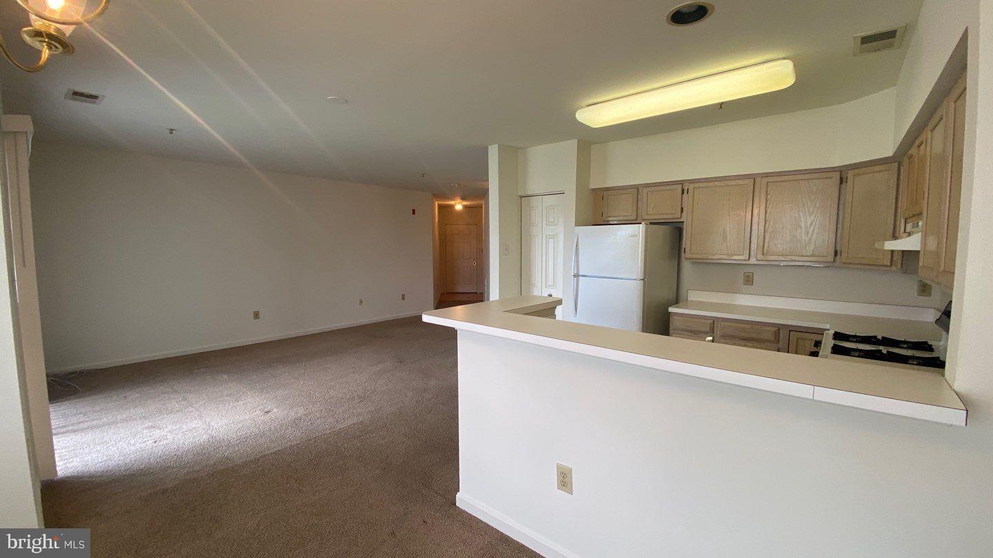 306 Gatehouse Lane, Unit E Odenton, MD 21113 - Photo 4 of 14 a view of a kitchen with a stove