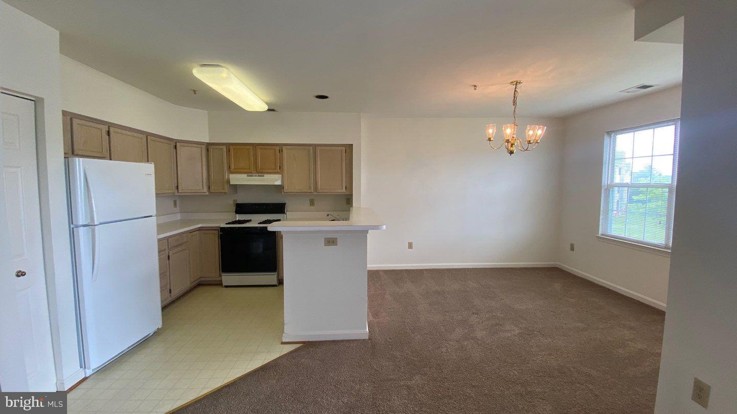 306 Gatehouse Lane, Unit E Odenton, MD 21113 - Photo 6 of 14 a kitchen with a refrigerator a sink dishwasher a stove and a refrigerator