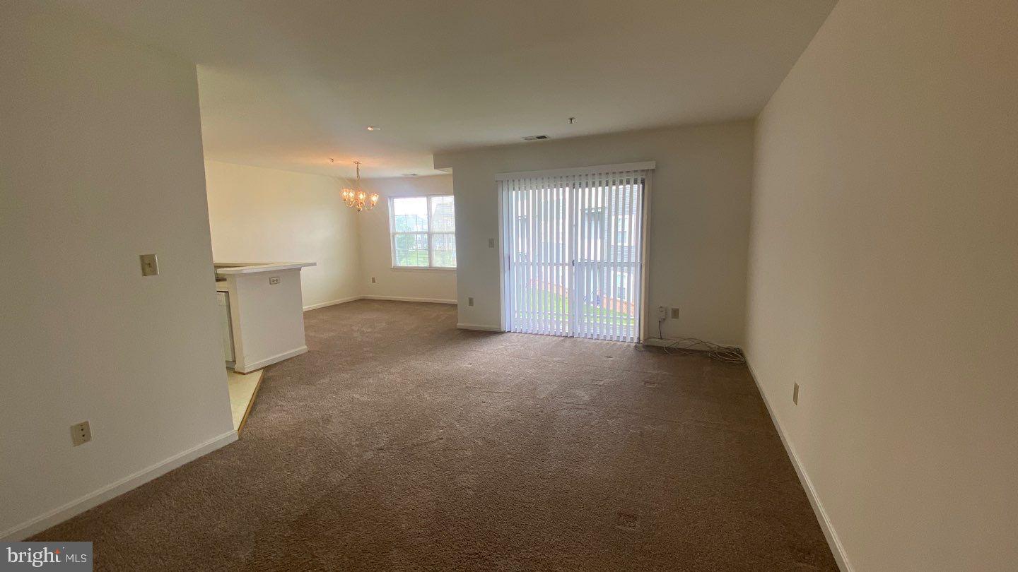 306 Gatehouse Lane, Unit E Odenton, MD 21113 - Photo 7 of 14 an empty room with windows