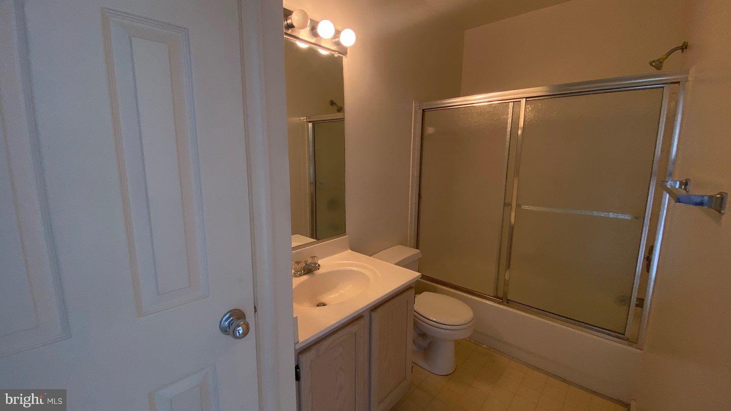 306 Gatehouse Lane, Unit E Odenton, MD 21113 - Photo 8 of 14 a bathroom with a granite countertop sink toilet and shower