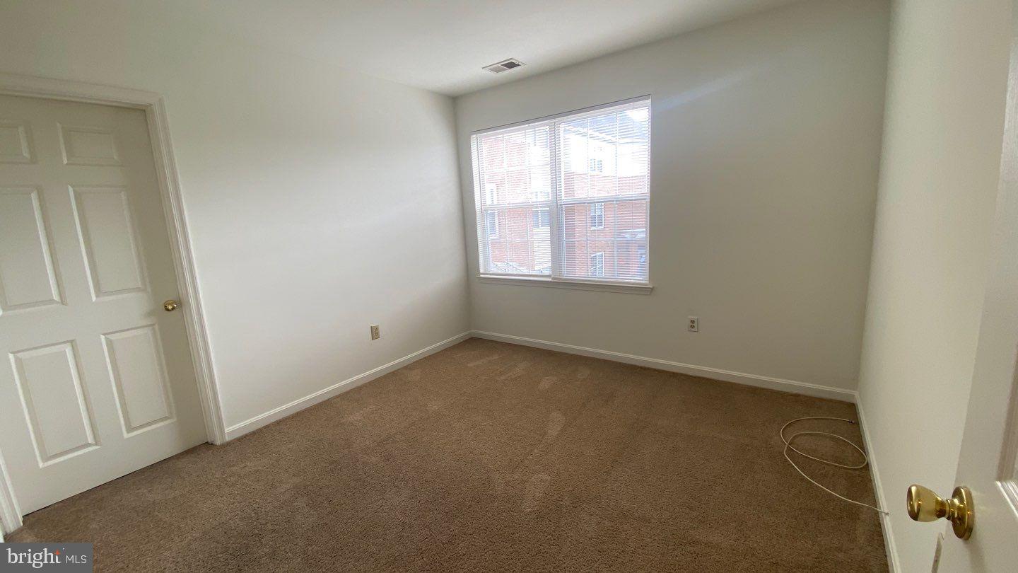 306 Gatehouse Lane, Unit E Odenton, MD 21113 - Photo 9 of 14 an empty room with windows
