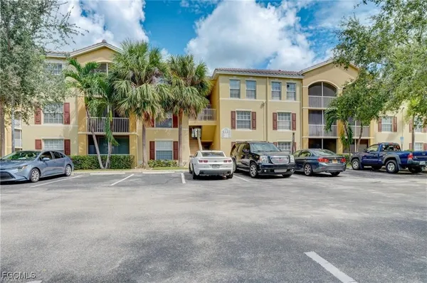 a view of a cars in front of a building