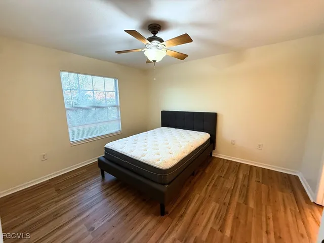 a living room with a bed furniture and a window