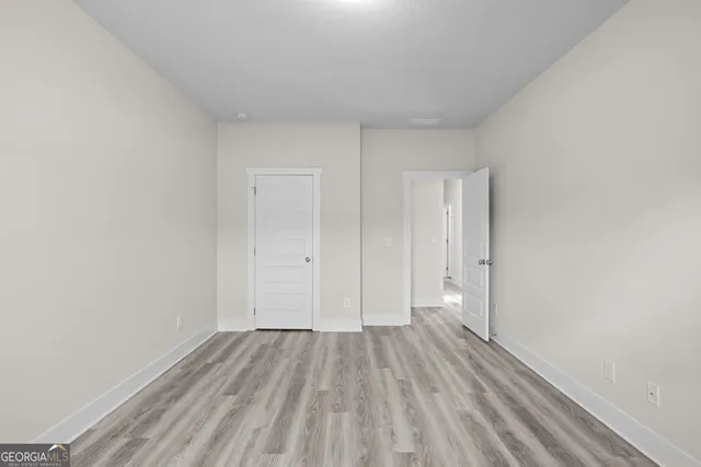 a view of a room with wooden floor