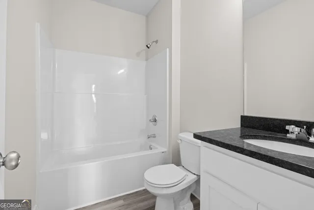 a bathroom with a sink a toilet and a bathtub