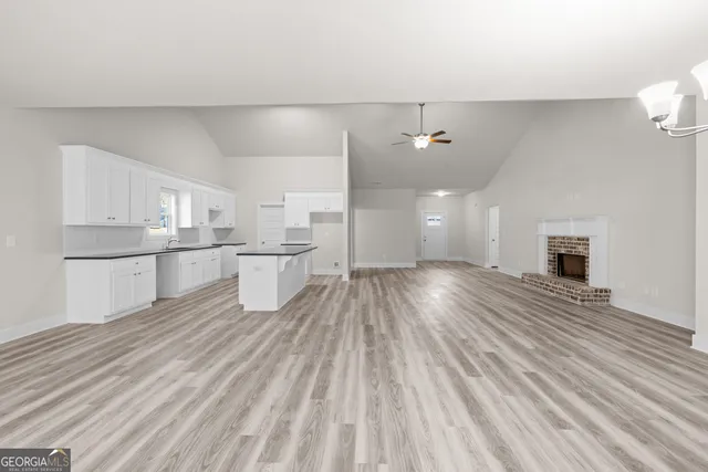 a view of a kitchen with wooden floor and windows