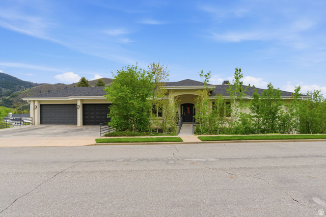 1878 East Ridge Point Drive Bountiful, UT 84010 - Photo 1 of 92 View of front of house featuring stucco siding, a garage, concrete driveway, a mountain view, and a shingled roof