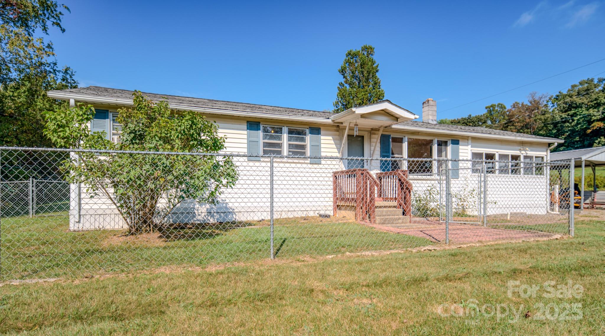 531 Bryson Road Candler, NC 28715 - Photo 1 of 45 a front view of a house with a garden