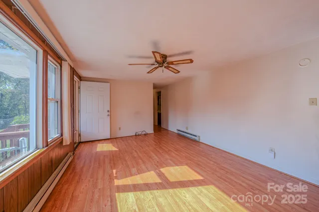a view of a livingroom with a ceiling fan and window