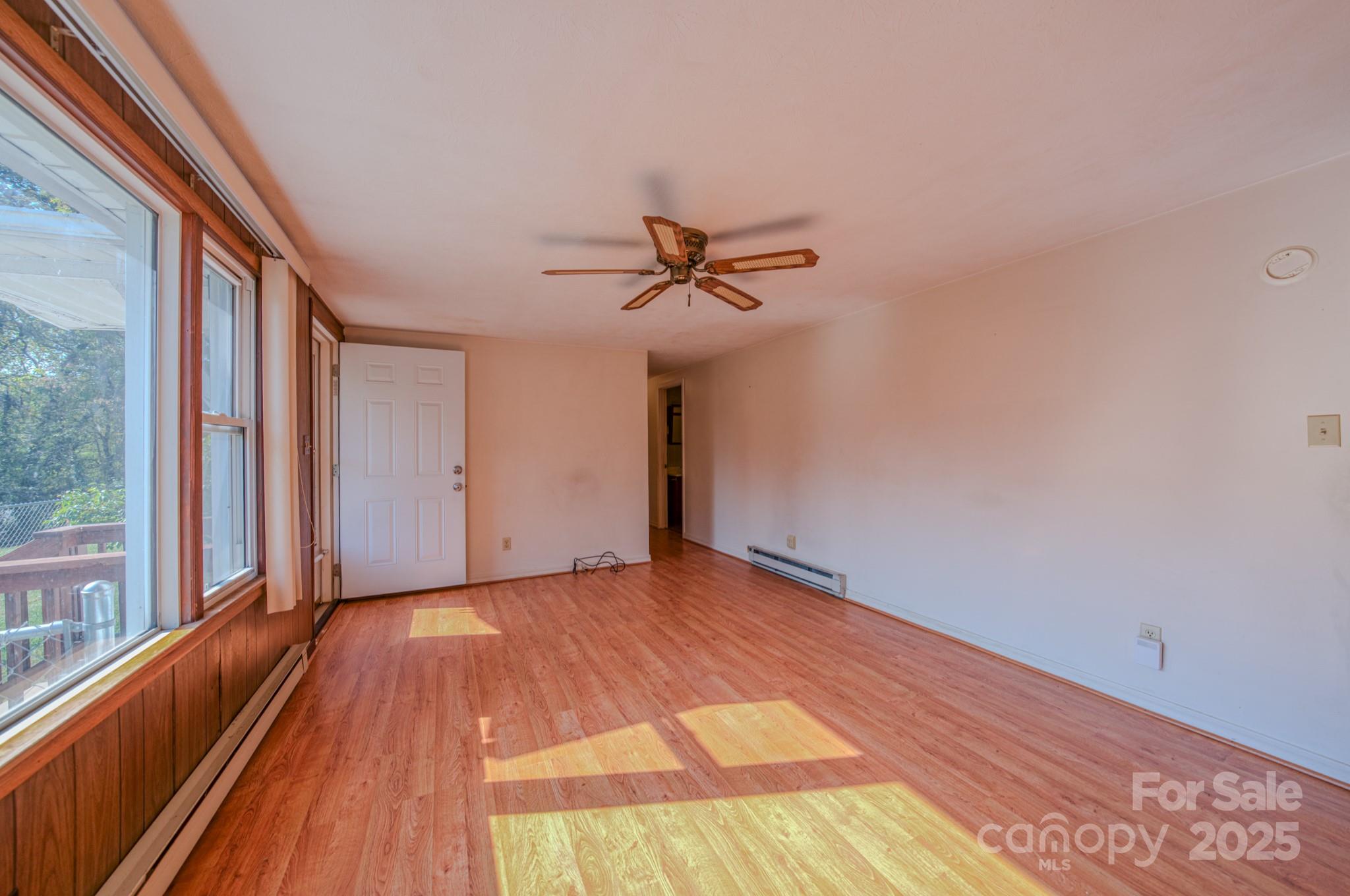 531 Bryson Road Candler, NC 28715 - Photo 12 of 45 a view of a livingroom with a ceiling fan and window