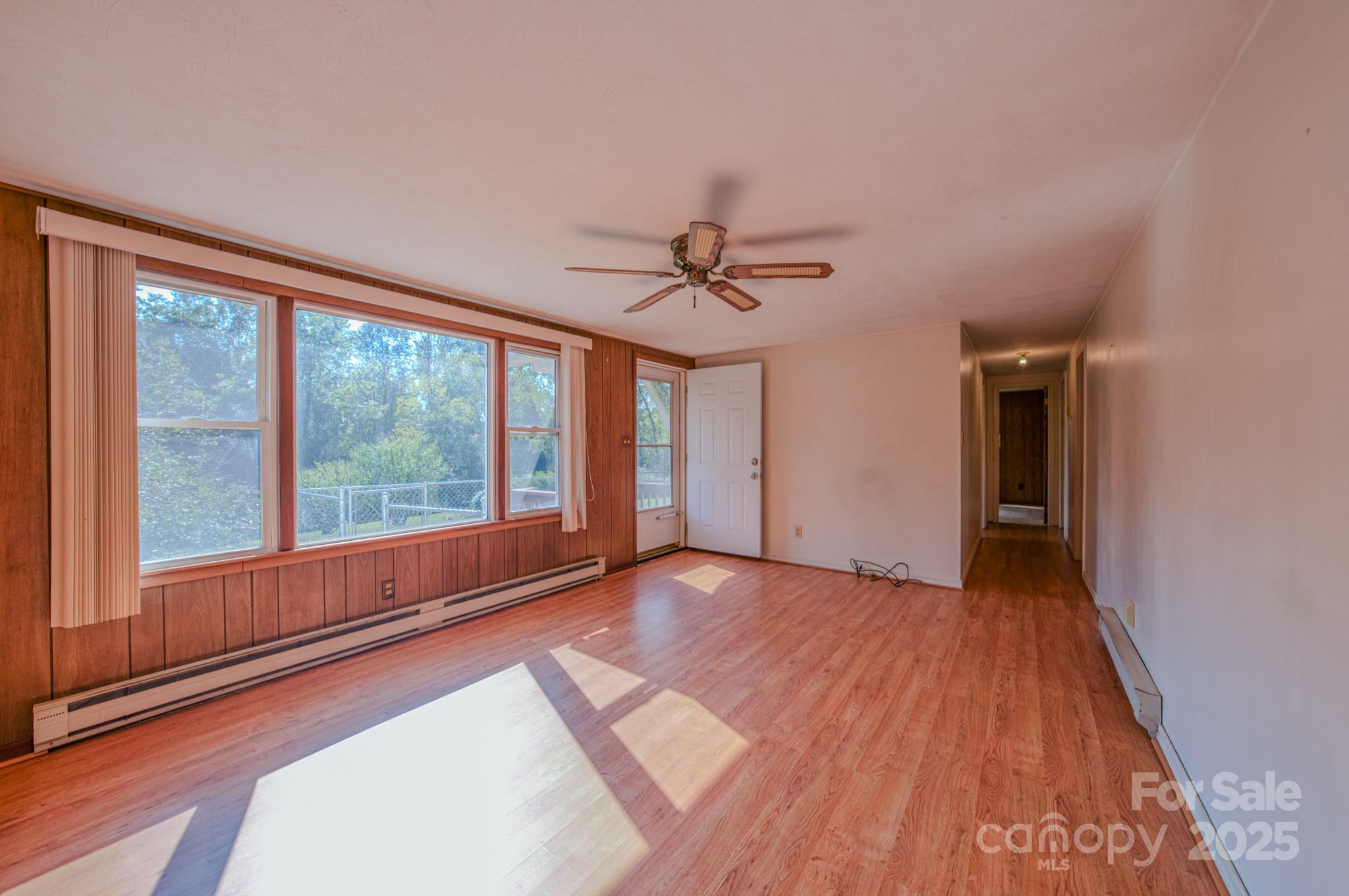531 Bryson Road Candler, NC 28715 - Photo 13 of 45 a view of an empty room with a window and wooden floor