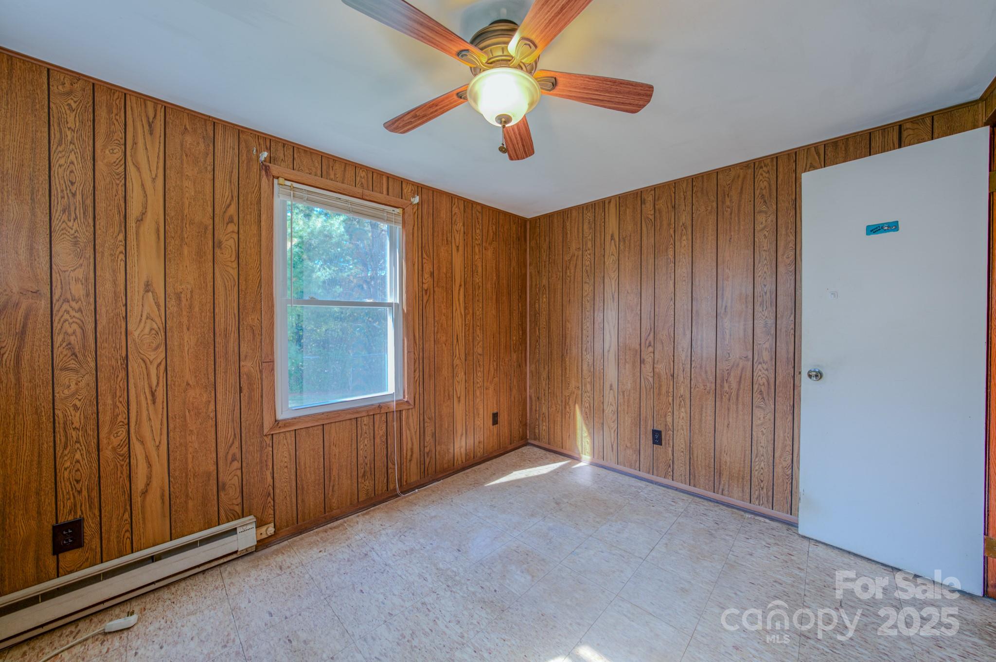 531 Bryson Road Candler, NC 28715 - Photo 17 of 45 an empty room with windows and fan