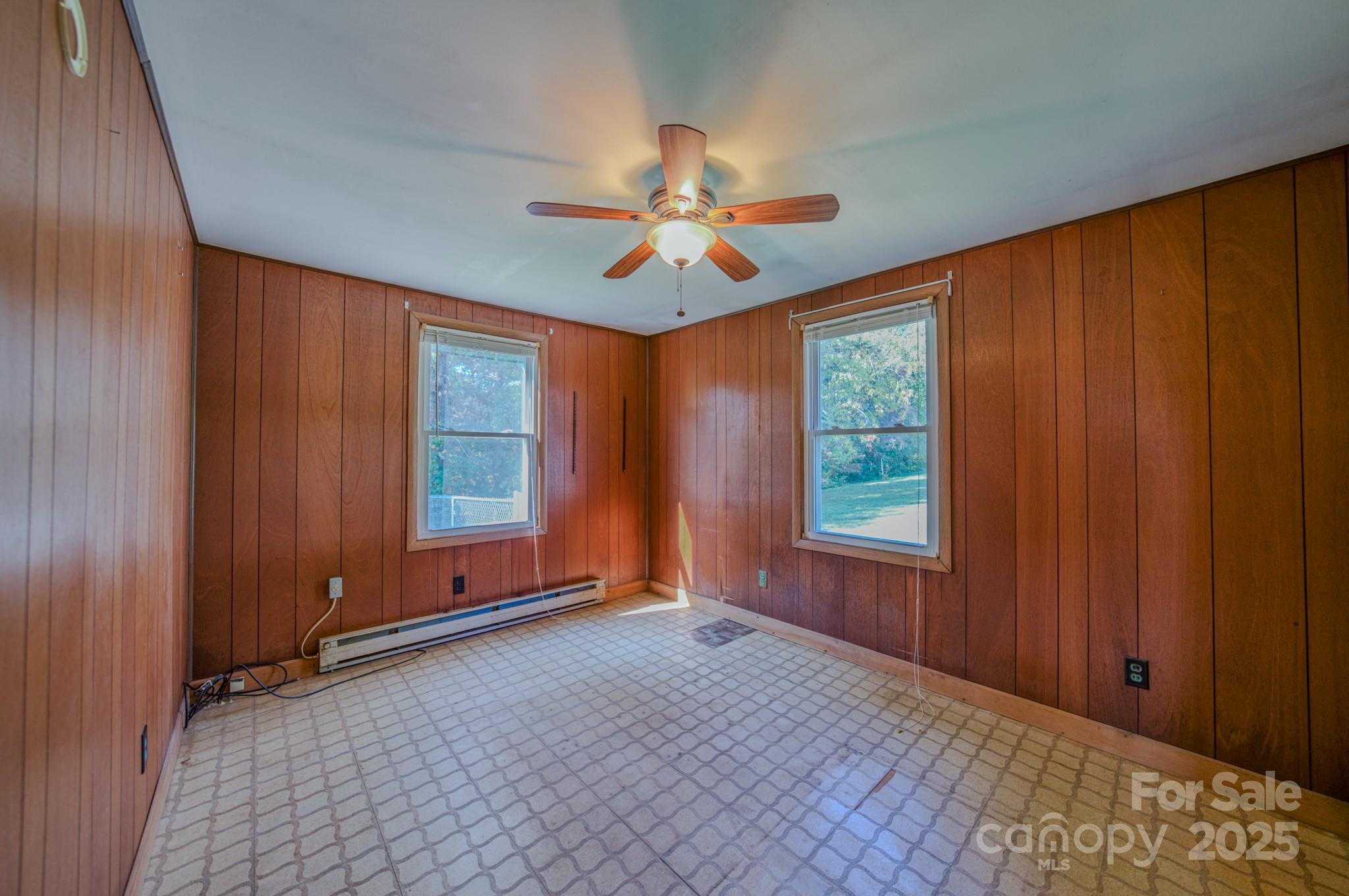 531 Bryson Road Candler, NC 28715 - Photo 22 of 45 an empty room with windows chandelier fan and windows