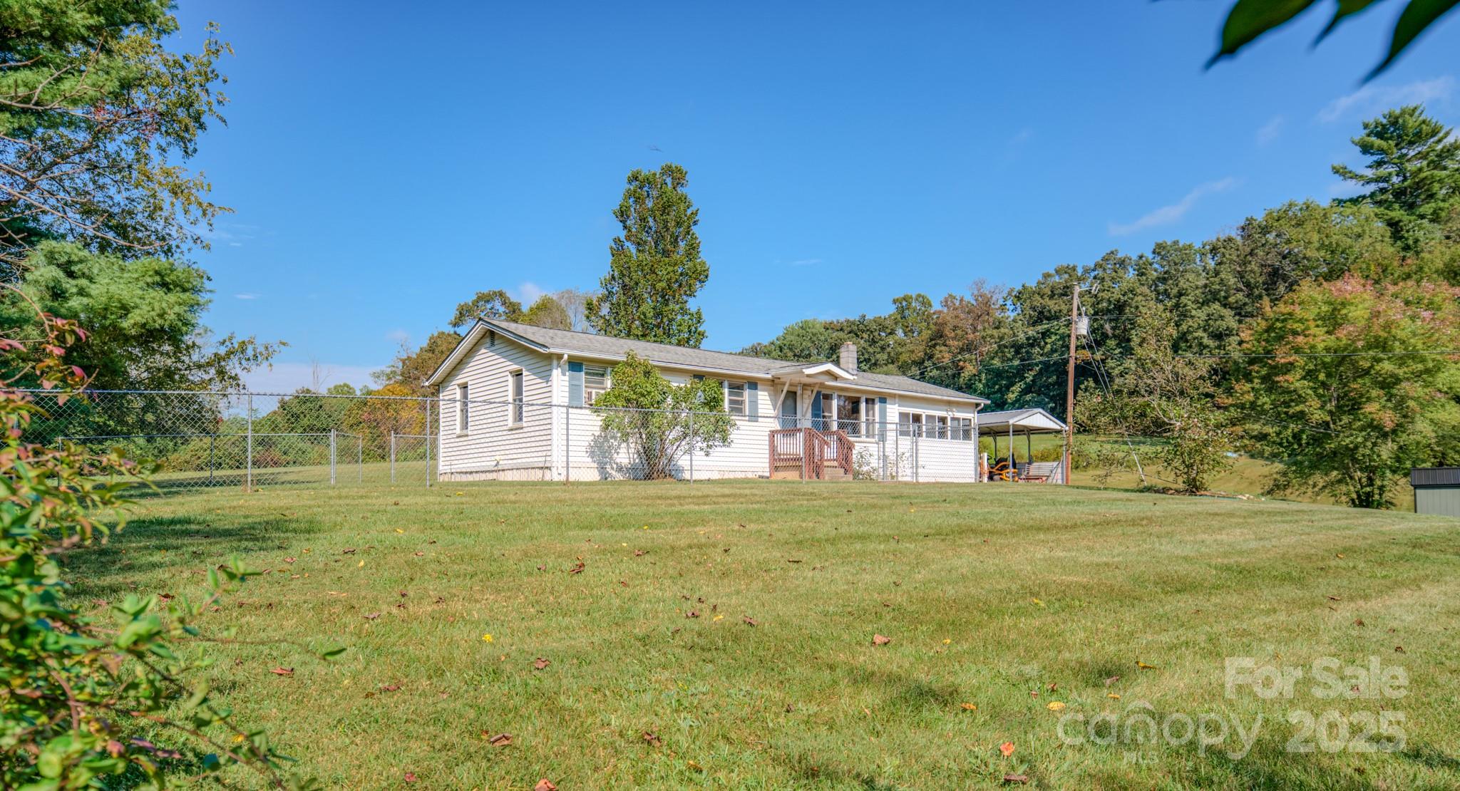 531 Bryson Road Candler, NC 28715 - Photo 6 of 45 a front view of a house with a garden
