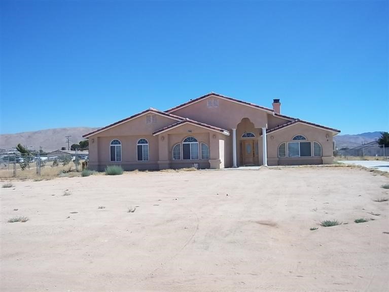 21595 Viento Road Apple Valley, CA 92308 - Photo 1 of 1 a front view of a house with a yard covered in snow