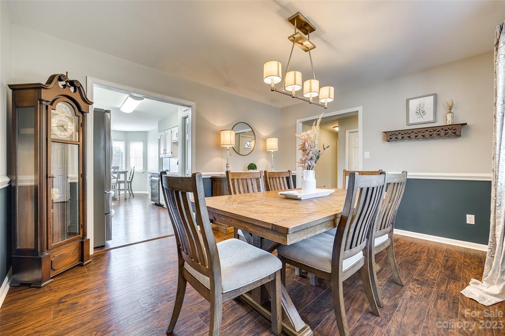 339 Gold Hill Road Fort Mill, SC 29715 - Photo 14 of 48 a view of a dining room with furniture and wooden floor